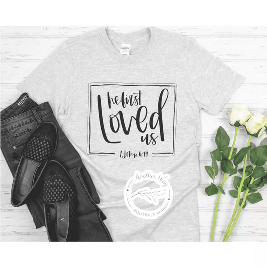 "He first Loved Us" - Another Way Boutique